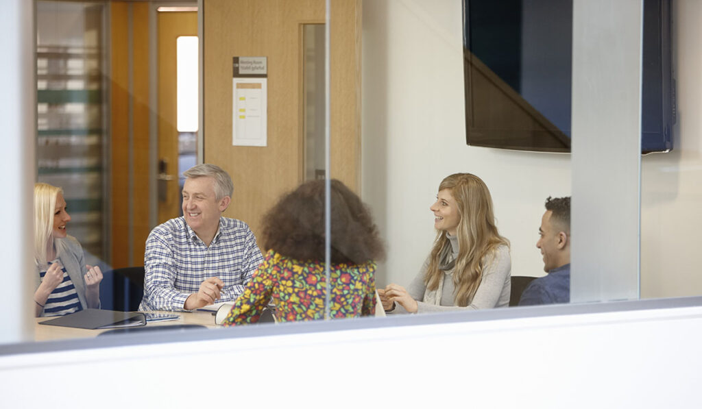 Businessmen and women meeting at conference table